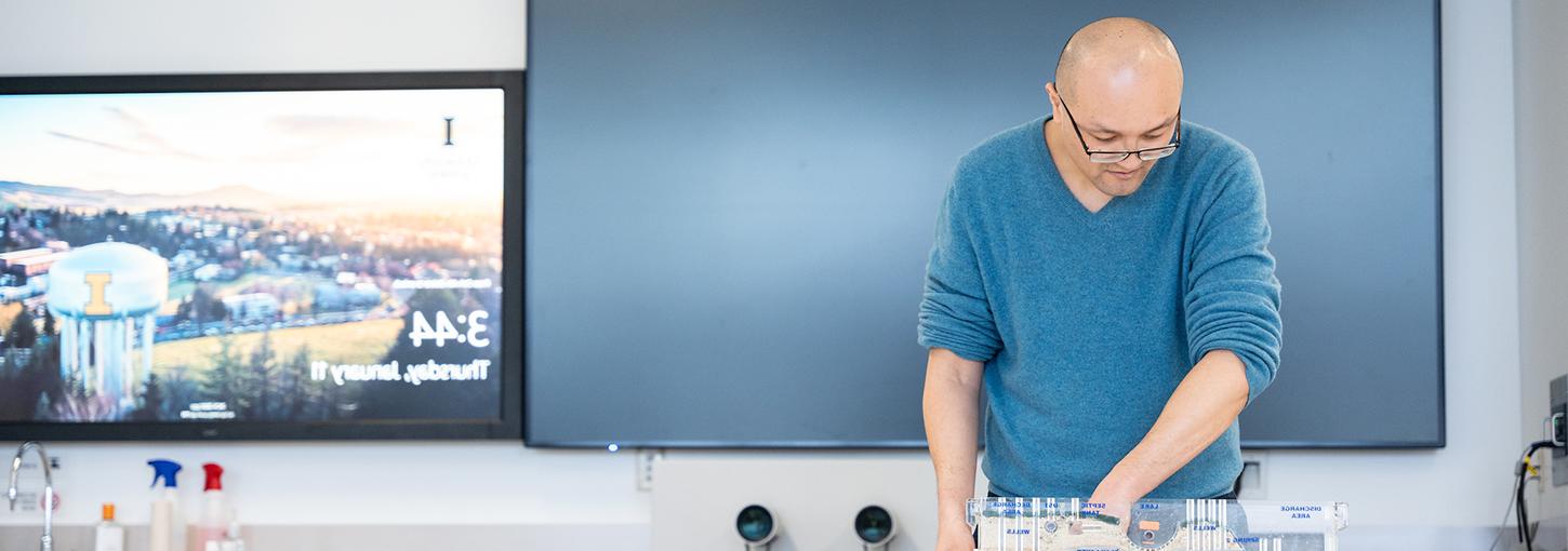 Assistant Professor Meng Zhao works with a scale hydrological model in the laboratory.